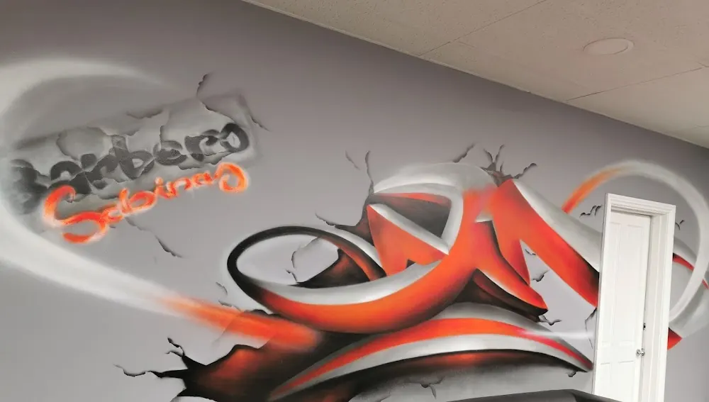 The orange and black graffiti mural inside the shop