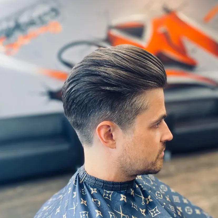 A side-parted cut with a fade, from behind